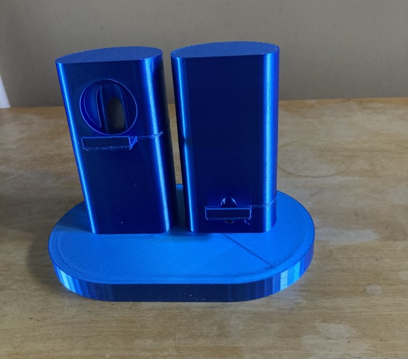 A blue dual holder on an oval base, two upright stands side by side