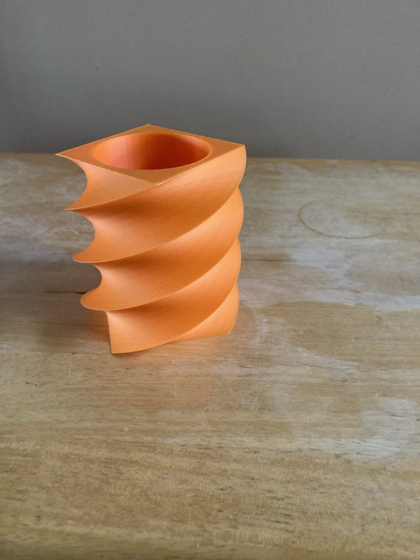 The same orange spiral pen holder from a slightly different angle