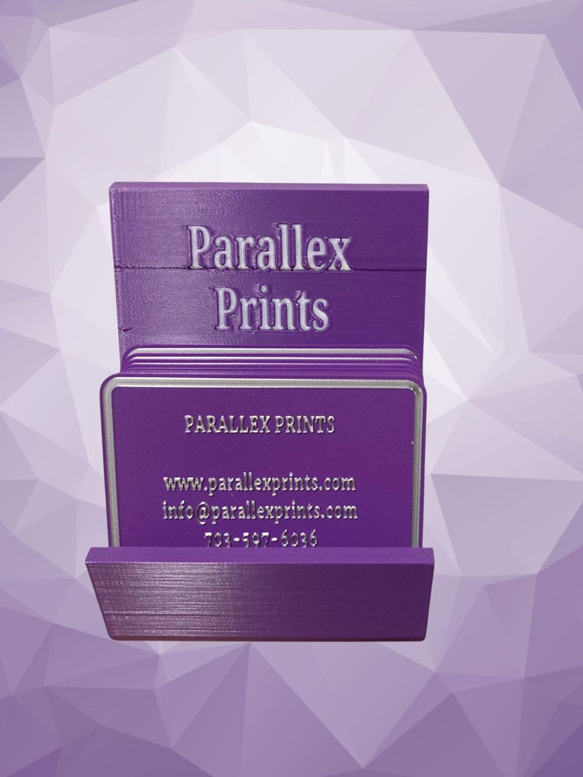A purple business card holder with Parallex Prints cards